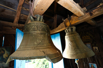 Fototapeta premium Old church bell and prefabricated structure. Close up of old metal, cracked, orthodox church bells. Selective focus. The concept of Orthodoxy.