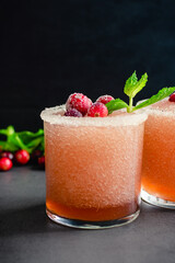 Cranberry Margaritas Garnished with Sugared Cranberries and Mint: Frozen margarita tequila cocktails rimmed with sugar and salt