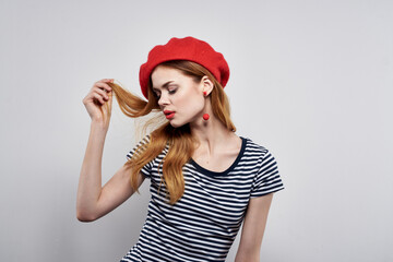 cheerful woman in a striped t-shirt red lips gesture with his hands model studio