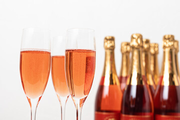 Glasses and bottles of rose champagne or sparkling wine. Christmas, new year party, birthday or wedding celebration concept
