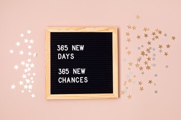 365 new days, 365 new chances. Letter board with motivational quote on pink background. New year...
