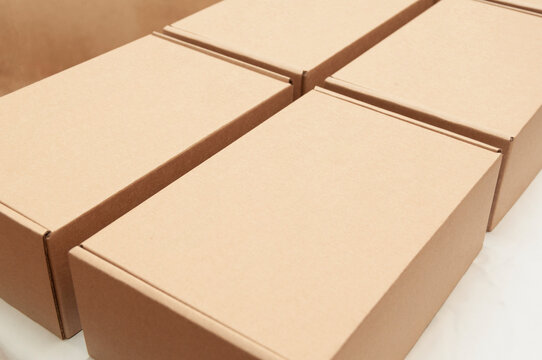Four cardboard shipping boxes on a table