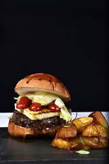 beef burger sandwich with cherry cheese, rustic potatoes, salad and brioche bread