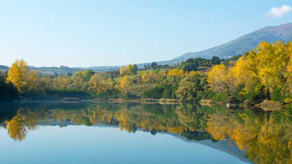 Fototapeta na wymiar Autumn landscape with panoramic reflection on the lake.