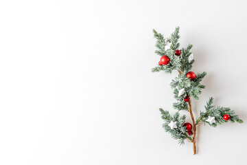 Fototapeta na wymiar Christmas Background. Fir tree branch with decorations on white background. Flat lay. Minimal concept. Top view
