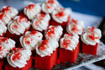 Individual red velvet sponge cakes on a serving dish