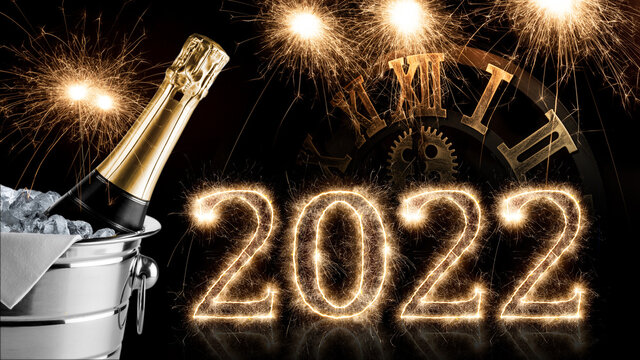 2022 sparkler number with clock and champagne bottle in cooler black. happy new year eve dark background
