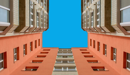 Photo of the orange building corner with sky - Powered by Adobe