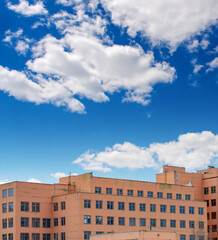 Photo of old red retro building with sky