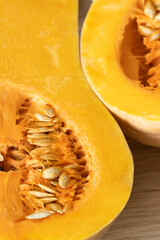 orange pumpkin with seeds cut in half close-up