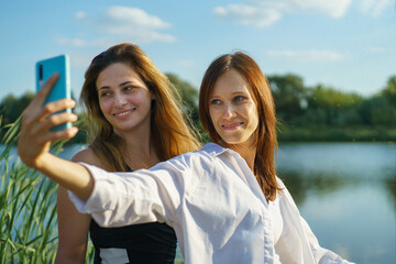 Women friend enjoying activities in nature take selfie by smartphone