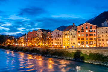 Fototapeta na wymiar Innsbruck, Austria. Colorful houses by the river at dusk on October 17,2012.