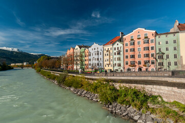 Innsbruck, Tyrol, Austria. Colorful houses and river inn on a sunny day with blue sky on october 18, 2021.