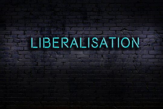 Night view of neon sign on brick wall with inscription liberalisation