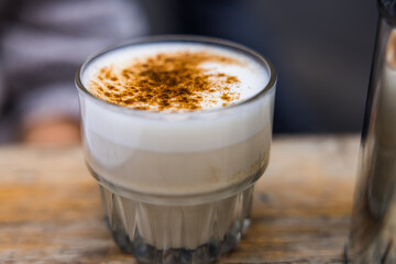 Closeup shot of a glass of Chai Tea on a wooden surface