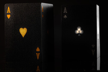 Obraz premium Black poker cards on a black background. Stylish composition. Casino, online casino, gambling, poker, gambling business, game strategy, luxury, risk, cash flow, hobby.