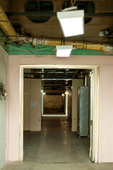 the lobby of an abandoned loft-style building with high ceilings and white lights