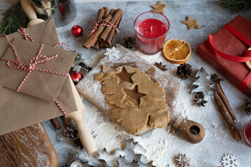 Traditional Christmas homemade gingerbread cookies, cinnamon and New Year's letters and gift boxes. Flat lay with copy space.
