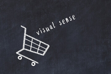 Chalk drawing of shopping cart and word visual sense on black chalboard. Concept of globalization...