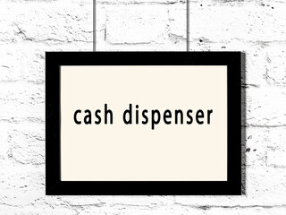 Black frame hanging on white brick wall with inscription cash dispenser