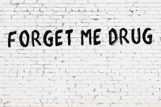 Inscription forget me drug painted on white brick wall