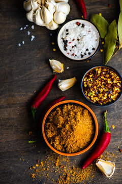 Bowl of adjika spice with dried chilli, chilli peppers, salt, garlic and bay leaves on a  table