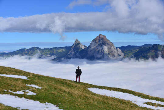 Rear view of a man looking at Grosser Mythen mountain landscape, Stoos, canton Schwyz, Switzerland