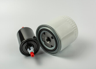 white oil and black fuel filter on a white background. timely car maintenance