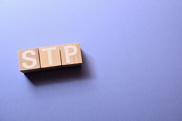 The word cubes formed STP It's an abbreviation for Segmentation, Targeting,  Positioning. Copy...