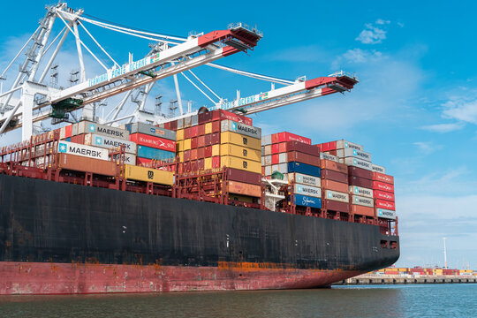 Crane unloads the containershipLe Havre, France - July 29, 2021: Crane unloading  containership Hamburg with containers of Maersk, Hamburg Sud and MCS in the port of Le Havre