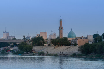Baghdad, Iraq - October 11, 2021: Evening View of Al Takarta Mosque Overlooking on Tigris River...