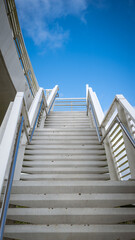 Background Architecture White Stairs Ascending to a Bridge up to Bright Blue Sky Vertical with Copy Space