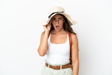 Obraz na płótnie Canvas Young caucasian woman wearing a Pamela in summer holidays isolated on white background with glasses and surprised
