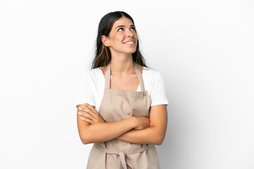 Restaurant waiter over isolated white background looking up while smiling