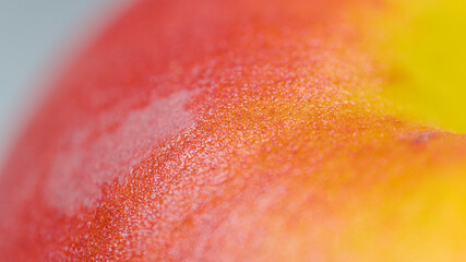 MACRO, DOF: Detailed shot of a ripe organic peach sitting on the dining table.