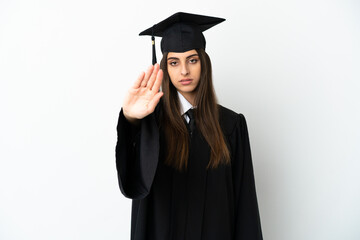 Young university graduate isolated on white background making stop gesture