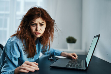 disgruntled woman in front of laptop upset work fatigue
