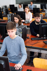 Fototapeta premium Group of people of different ages learning to use computers in classroom. High quality photo