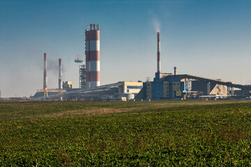 Fototapeta na wymiar Industrial landscape environmental pollution waste of thermal power plant. Big pipes of chemical industry enterprise plant