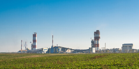 Fototapeta na wymiar Industrial landscape environmental pollution waste of thermal power plant. Big pipes of chemical industry enterprise plant