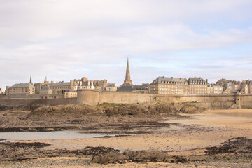 View of the walled city of Saint-Malo at low tide in late afternoon, France