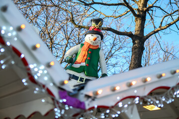 Inflatable snowman standing on the roof of a booth of the Christmas market of the Champs Elysées...