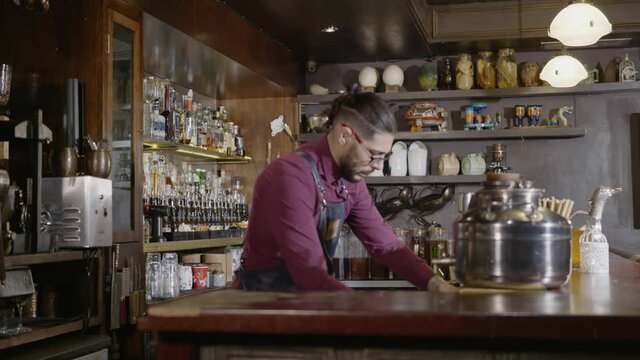 A bartender organizing his bar