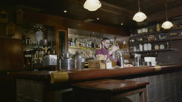 A bartender spins his spoon in the air