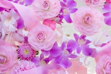 Arrangement of pink flowers and ribbons