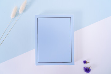 The sky blue card on the white sky blue table.
