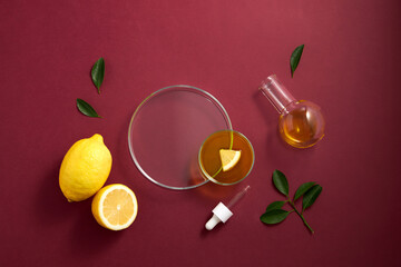 Red background with lemon extract top view. Close-up and red background. Template cosmetic mock up....