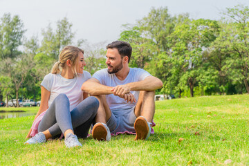Fototapeta premium athletic couple sitting for relax together after work out outdoors