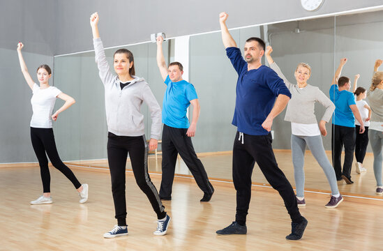 Group Of Adult People Warming Up Before Dance Training In Fitness Center