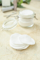 Fototapeta na wymiar Clean cotton pads on light background, closeup